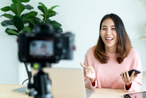 Girl wearing pink shirt talking to a camera