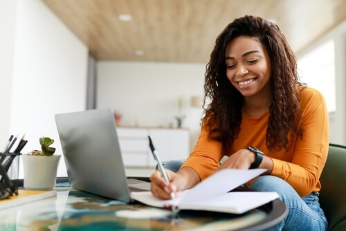 Girl wearing yellow shirt studying