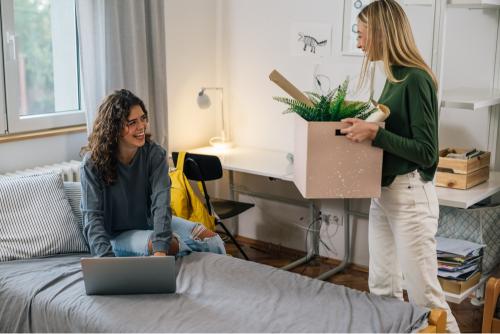 2 girls unpacking in a student accommodation 