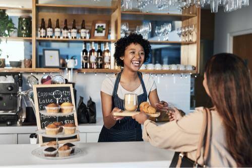 Barista giving the food and coffee to the customer 