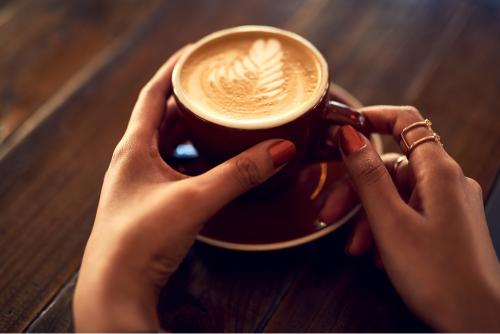 Person holding a cup of coffee 