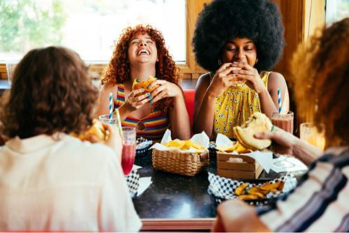 A group of people eating burgers 