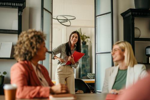 Girl entering a room with two colleagues 