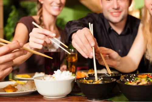 A group of people eating Chinese food