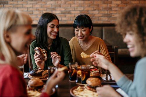 A group of people enjoying meal together 