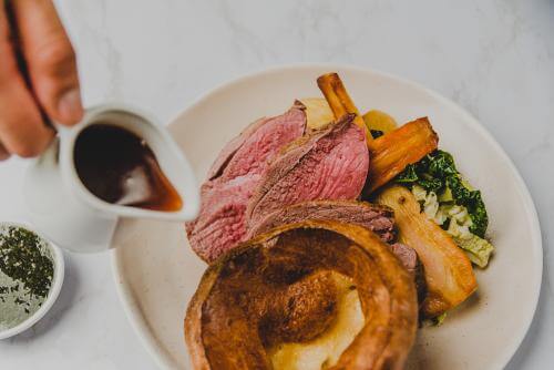 Sunday roast with meat , vegetables and gravy 