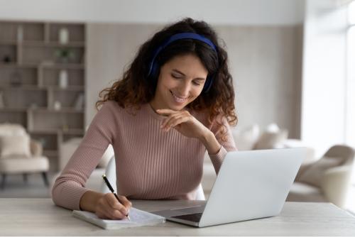 Girl using a laptop for AI tools for note-taking